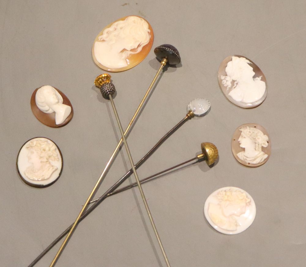 Four assorted mounted metal hatpins including amethyst and six carved cameo shells, five unmounted, largest 46mm.